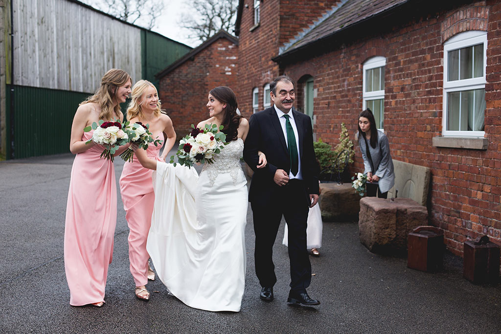 Bride and bridesmaids walking to the country house wedding venue