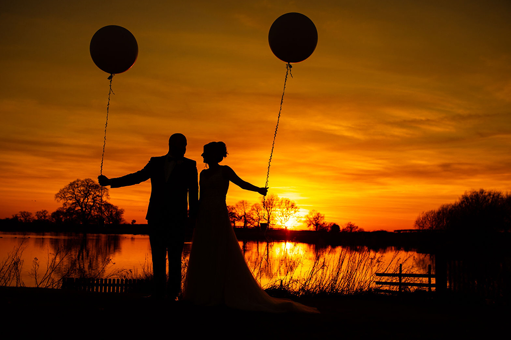 The happy newlyweds have a wedding photo in the sunset at their wedding in Cheshire