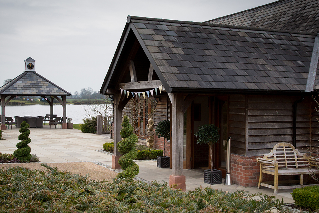 The entrance to the barn with a view of the clock tower and lake at Sandhole oak Barn