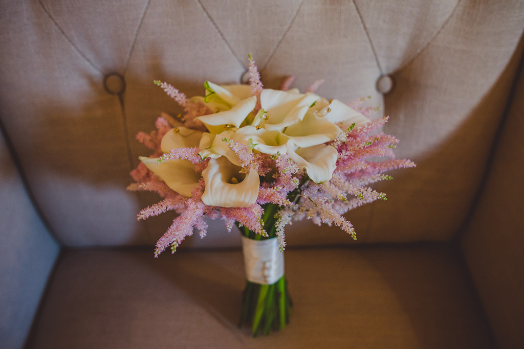 The brides bouquet was made from beautiful white calla lilies and pastel pink astilbe at this barn wedding at Sandhole Oak Barn 