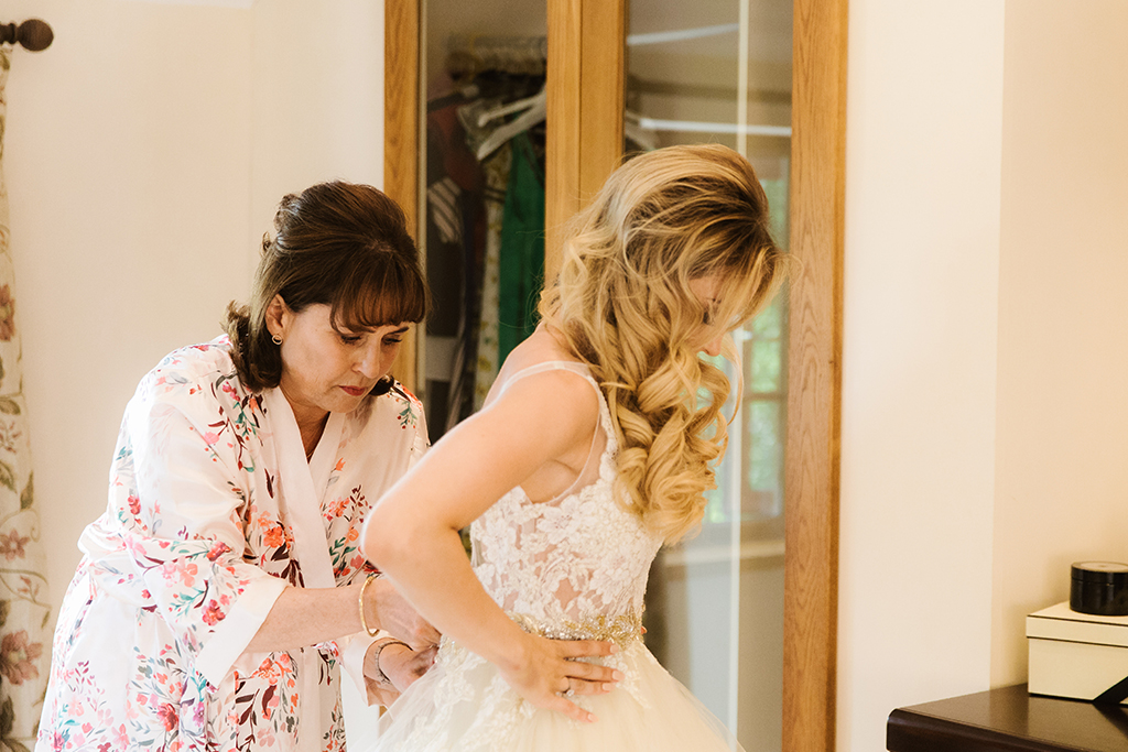 The bride prepares for her wedding at Sandhole Oak Barn in Cheshire