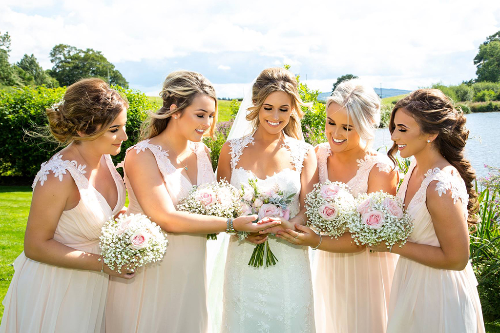 The bride enjoyed a moment with her bridesmaids after the wedding ceremony at Sandhole Oak Barn