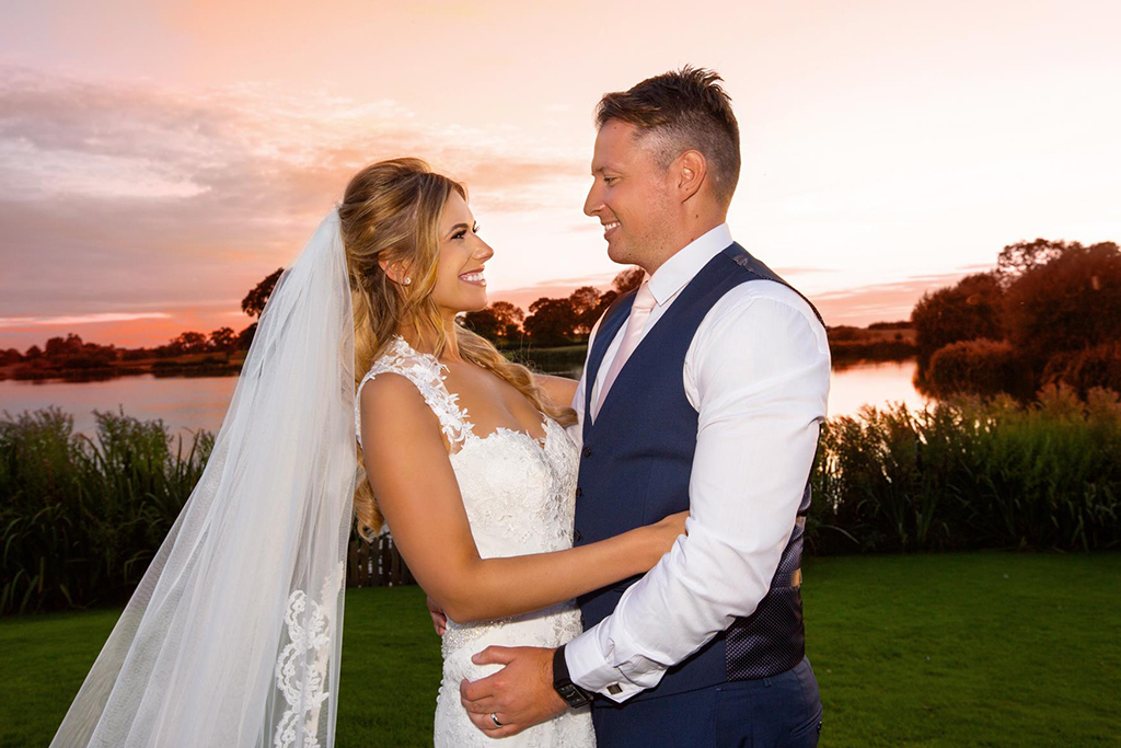 The bride and groom enjoy a moment on their wedding at this lakeside wedding venue