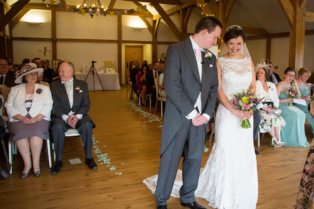 The bride and groom prepare to say their vows at this Cheshire barn venue