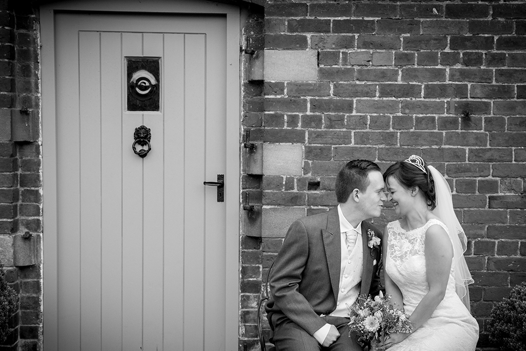 The bride and groom steal a moment together at Sandhole Oak Barn in Cheshire