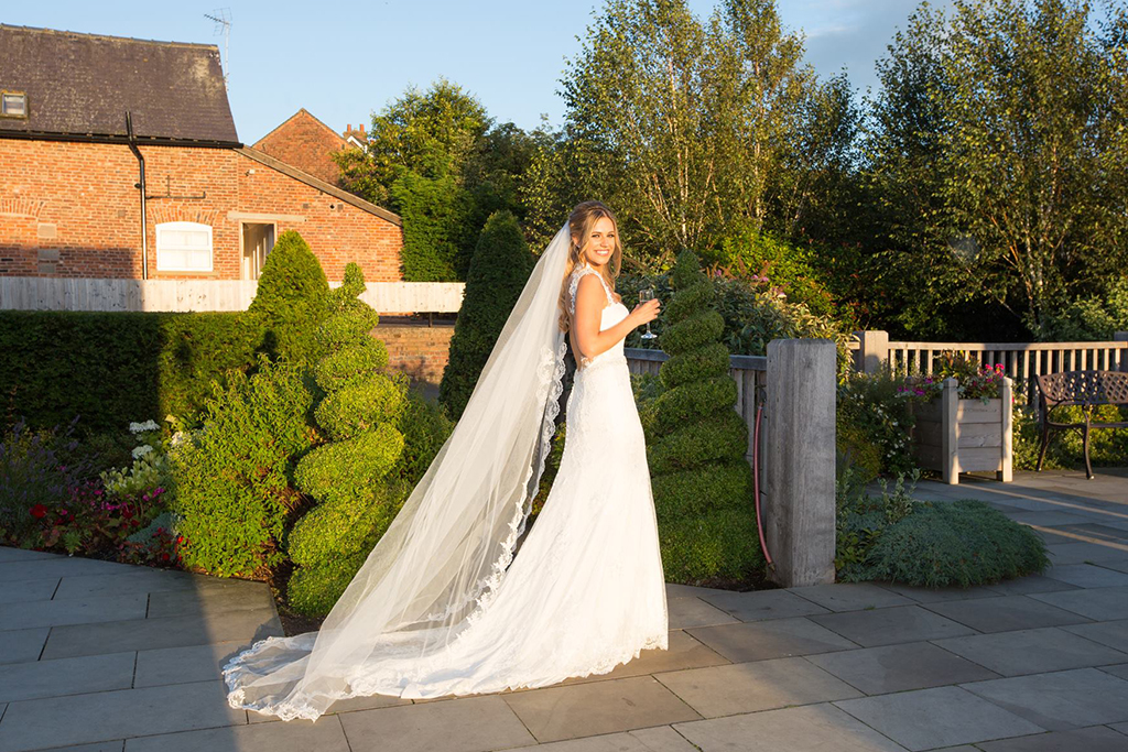 The bride looks stunning in her bridal gown at Sandhole Oak Barn in Cheshire