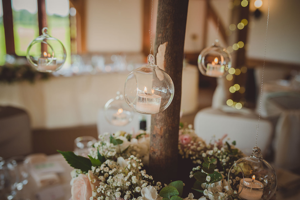 Elegant clear baubles filled with candles were used to decorate this barn wedding at Sandhole Oak Barn in Cheshire