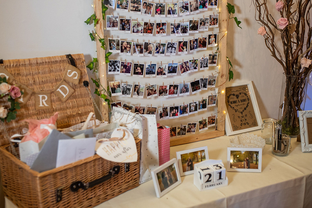 The card table was decorated with a displays of photos of the happy couple at Sandhole Oak Barn 