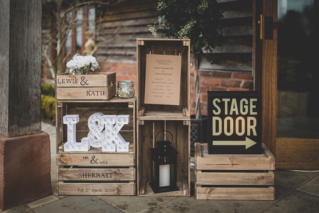 The couple created a display using personalised wooden crates at their barn wedding at Sandhole Oak Barn