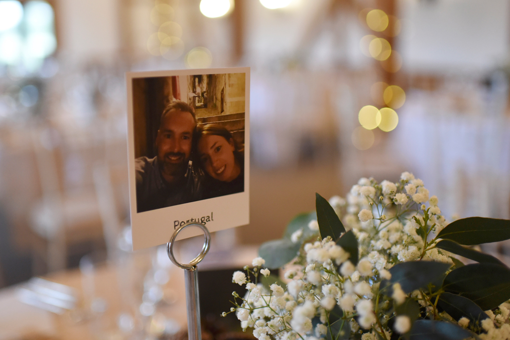The couple chose photos of themselves in place of table numbers at this barn wedding in Cheshire