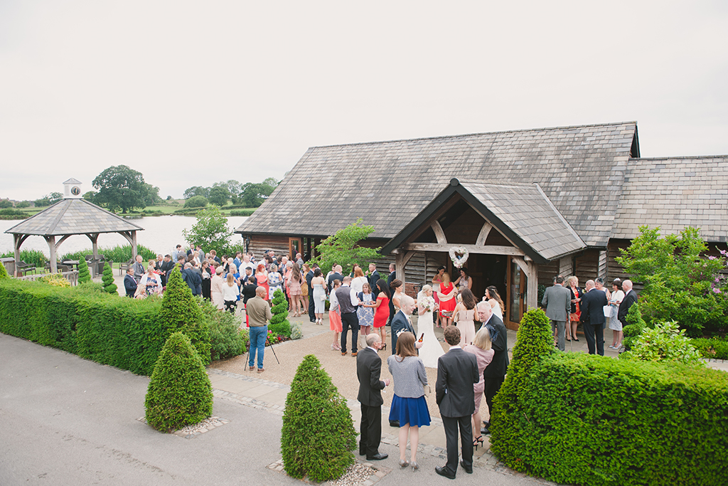 Guests enjoy the stunning countryside views outside in the courtyard during the drinks reception