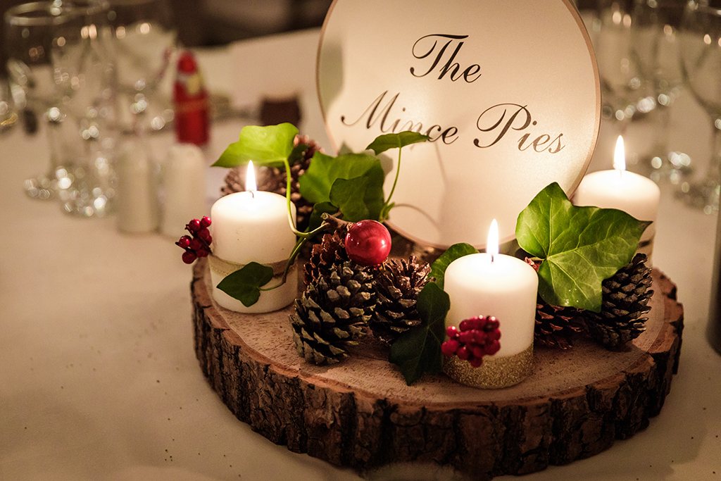 The couple chose festive table centre-pieces at this winter wedding at Sandhole Oak Barn in Cheshire