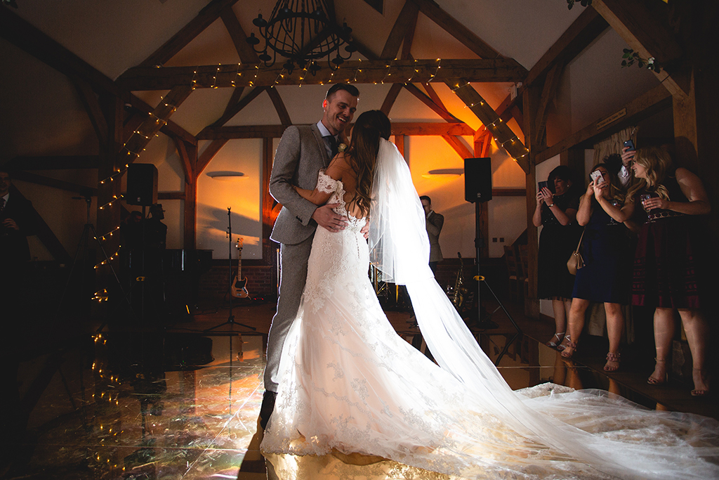 The bride and groom enjoy their first dance at their barn wedding at Sandhole Oak Barn in Cheshire