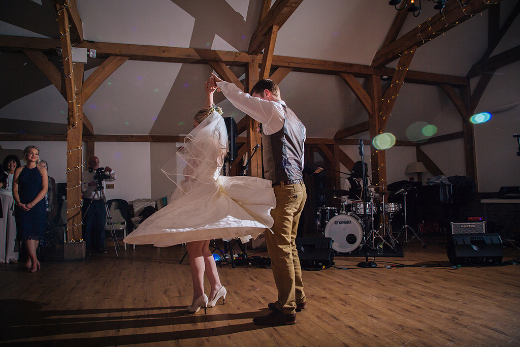 The happy newlyweds enjoy their first dance at their rustic barn wedding at Sandhole Oak Barn