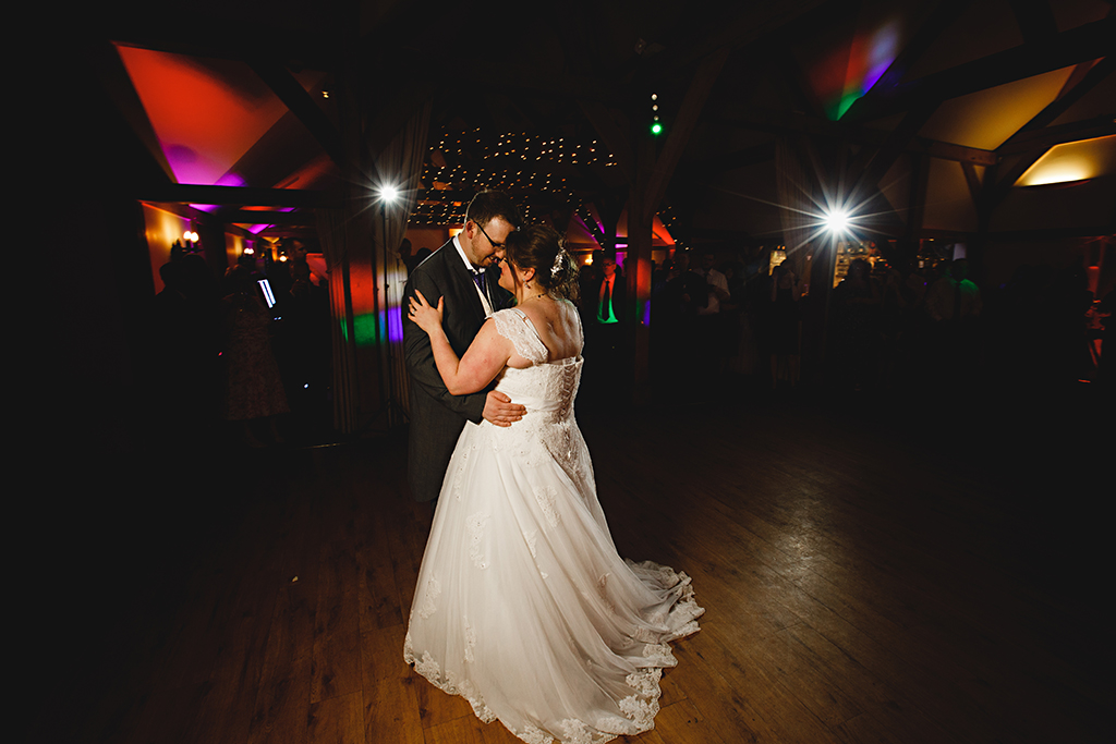 The bride and groom take to the dancefloor for their first dance at Sandhole Oak Barn