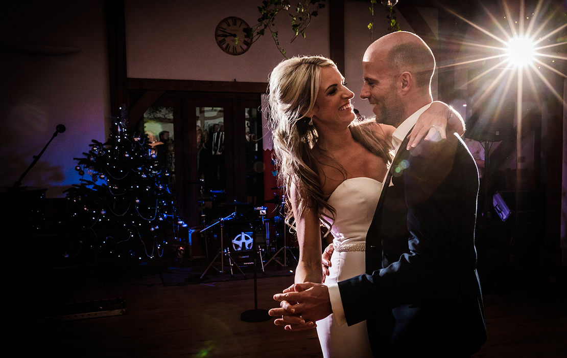 The couple enjoy their first dance at their festive winter wedding at Sandhole Oak Barn