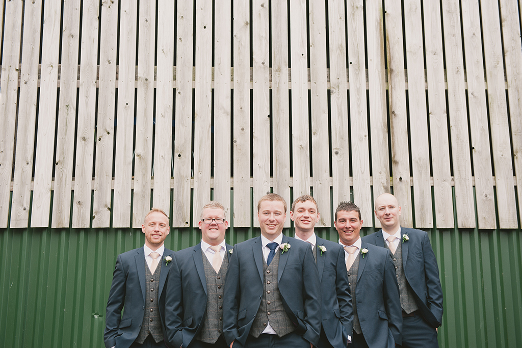 The groom and his groomsmen each wore blue suits with grey tweed waistcoats – wedding ideas
