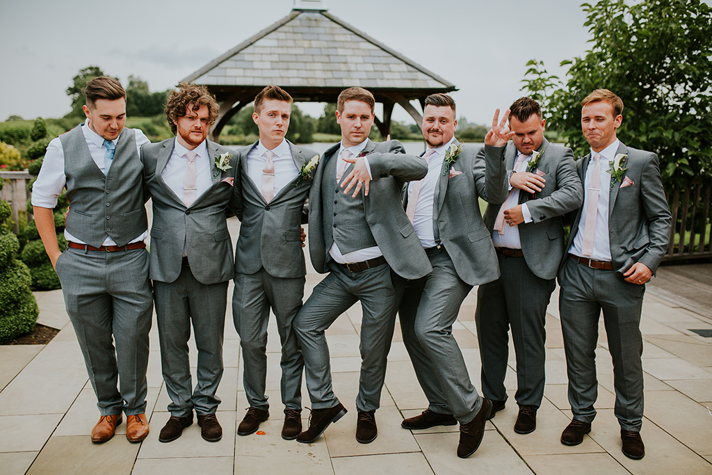 The groom and his groomsmen all wore grey suits with the groomsmen wearing light pink ties