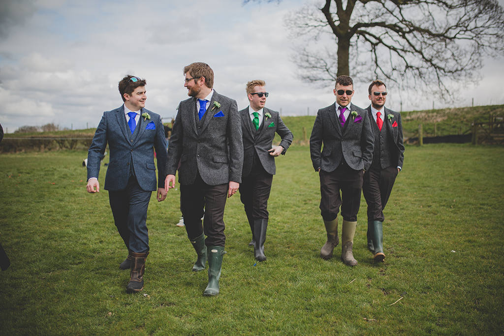 The Groom and Groomsmen wore three-piece wedding suits with grey tweed jackets and waistcoats at this Cheshire barn wedding.