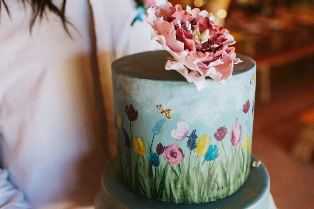 This beautiful hand painted wedding cake is just perfect for a summer barn wedding in Cheshire
