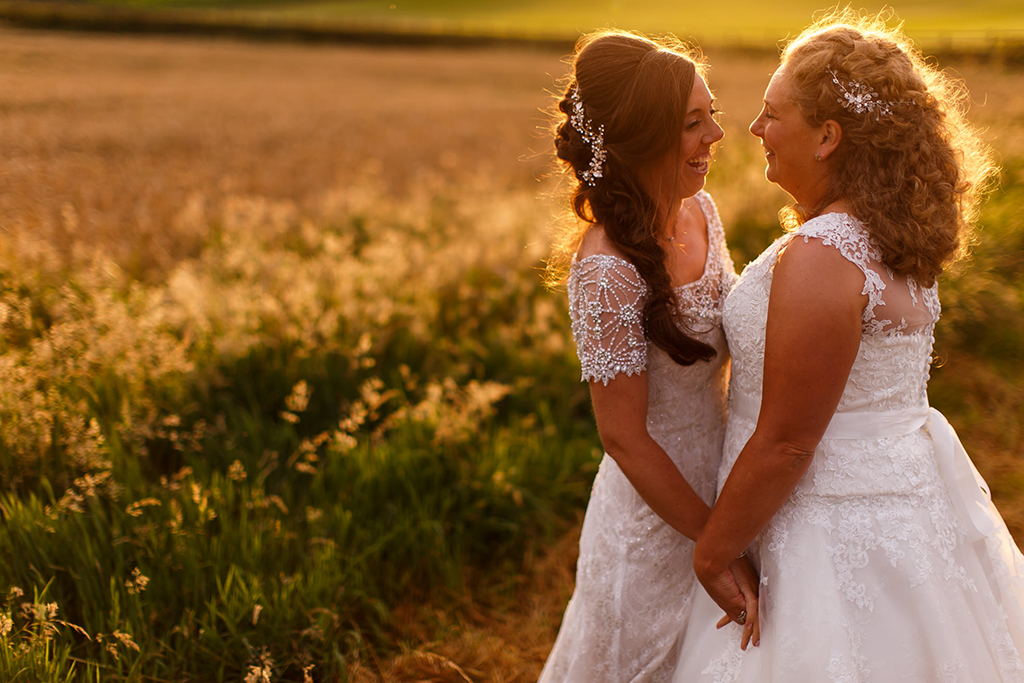 The happy newlyweds have their wedding photos taken in the surrounding fields at the rural wedding venue in Cheshire