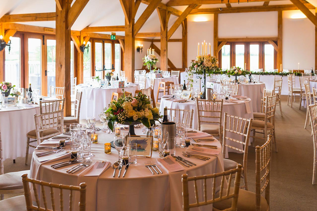 The Oak Barn is set up for the wedding breakfast at Sandhole Oak Barn wedding venue