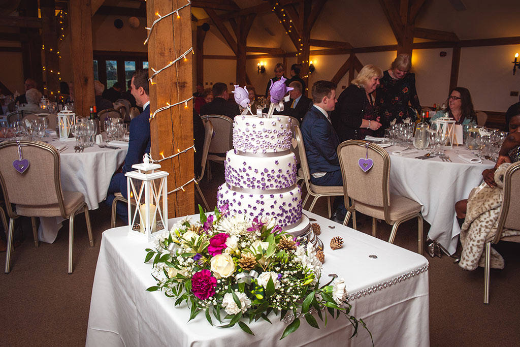 3 tier wedding cake with purple decoration at Kirsty and Richard's wedding at Sandhole Oak Barn