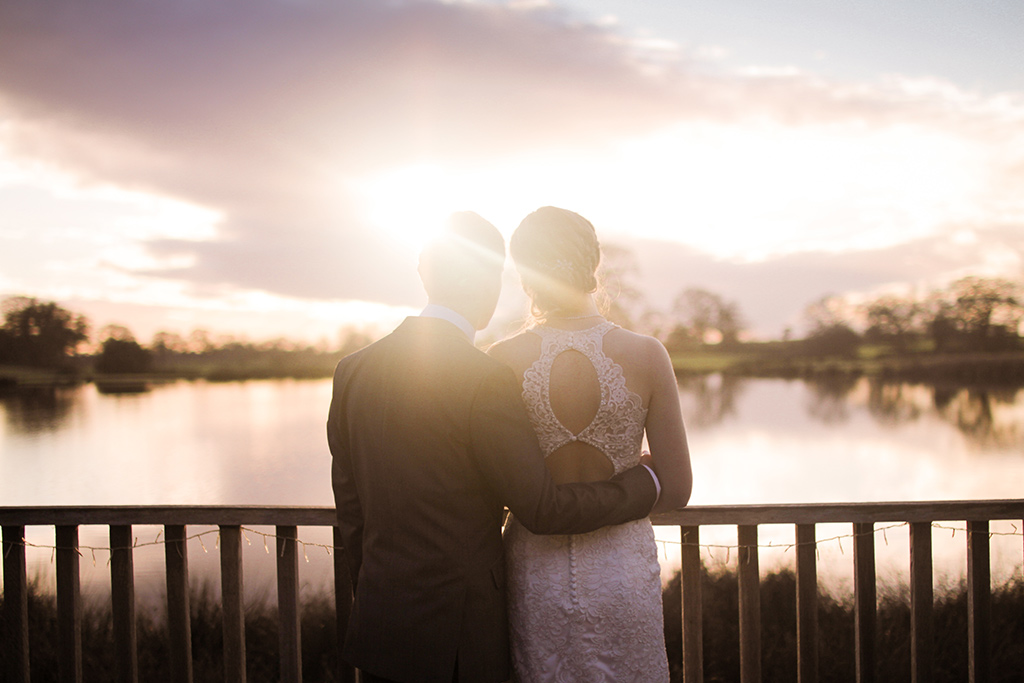 Kirsty and Richard watching the sun set at Sandhole Oak Barn