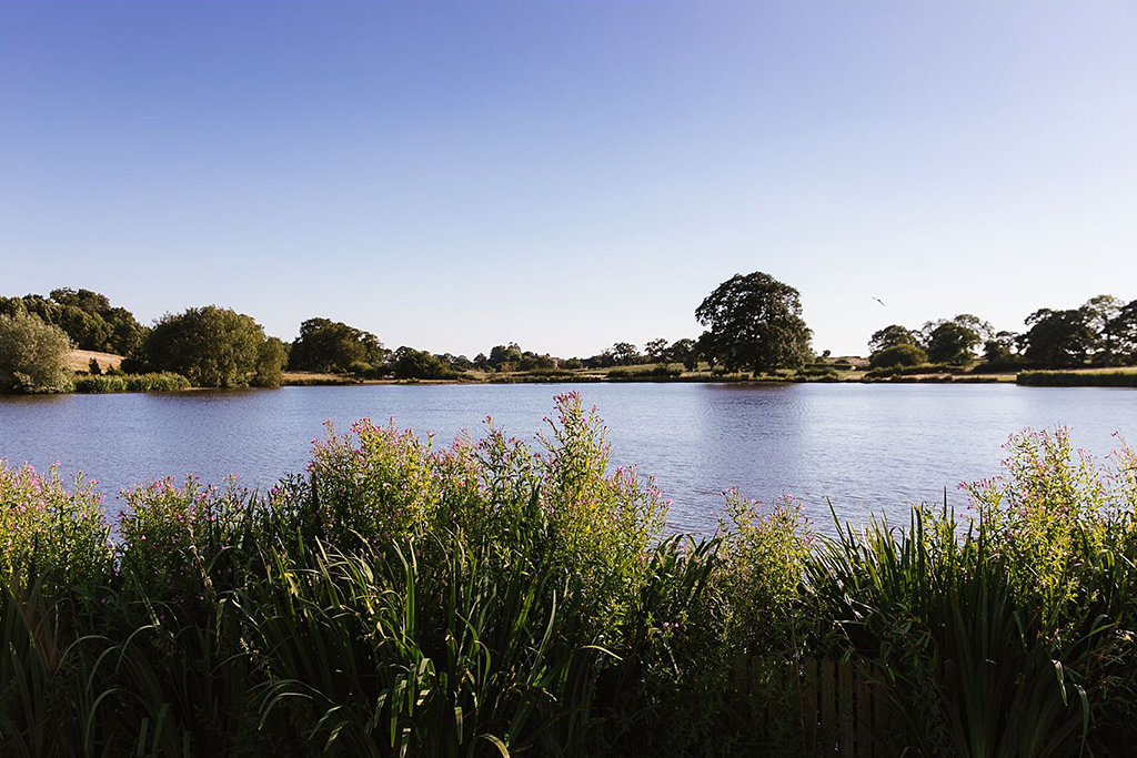 The lake at Sandhole Oak Barn offers the most amazing views and wedding photo opportunities for summer wedding