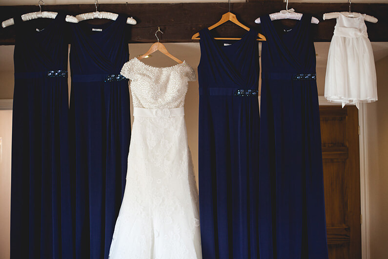 Lauren's white lacey dress and her navy bridesmaids dresses