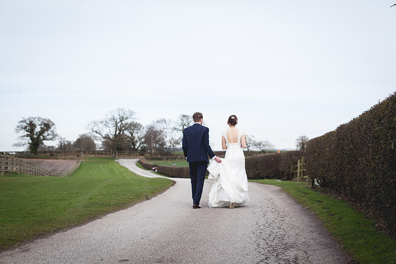Lauren and Danny taking a stroll in the beautiful grounds at Sandhole Oak Barn