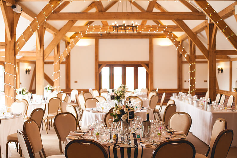 The rustic barn decorated in pastel flowers with navy and white stripes