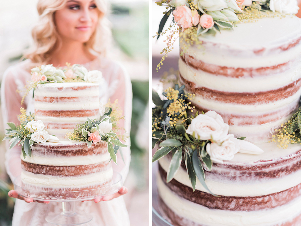 The bride shows off her pretty naked-wedding-cake at her barn wedding in Cheshire