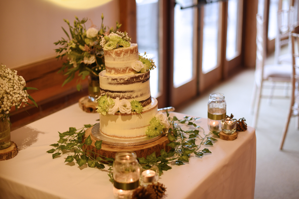 The couple chose a rustic semi naked wedding cake at this barn wedding near Manchester
