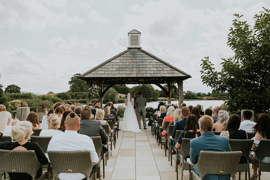 The bride and groom say their vows under the Clock Tower at this waterside wedding venue
