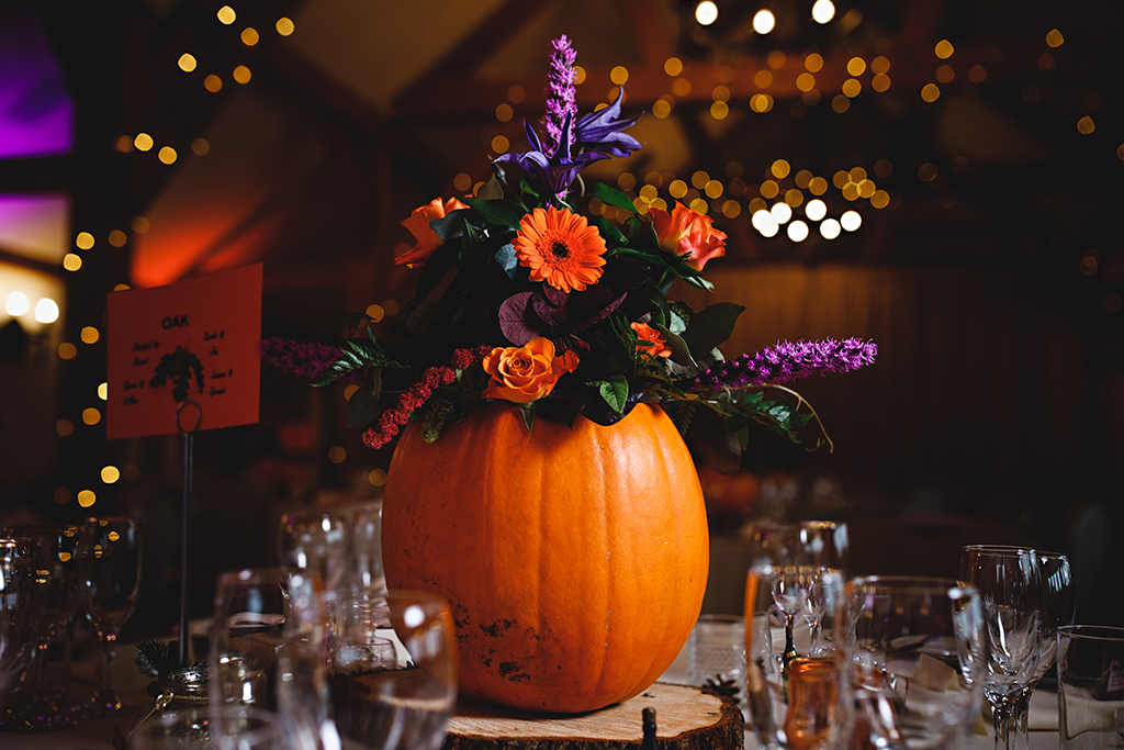 Pumpkins were used as vases for colourful flowers at this barn venue in Cheshire