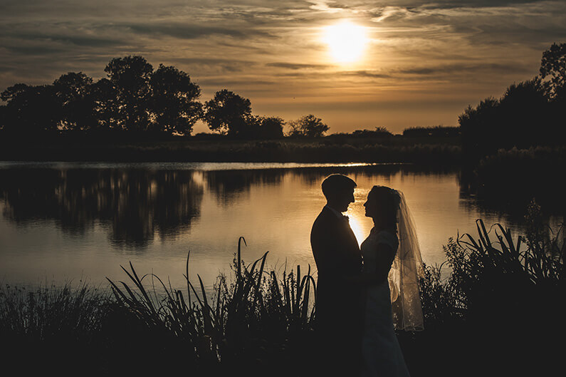 Rachel and Norman besides the lake at dusk
