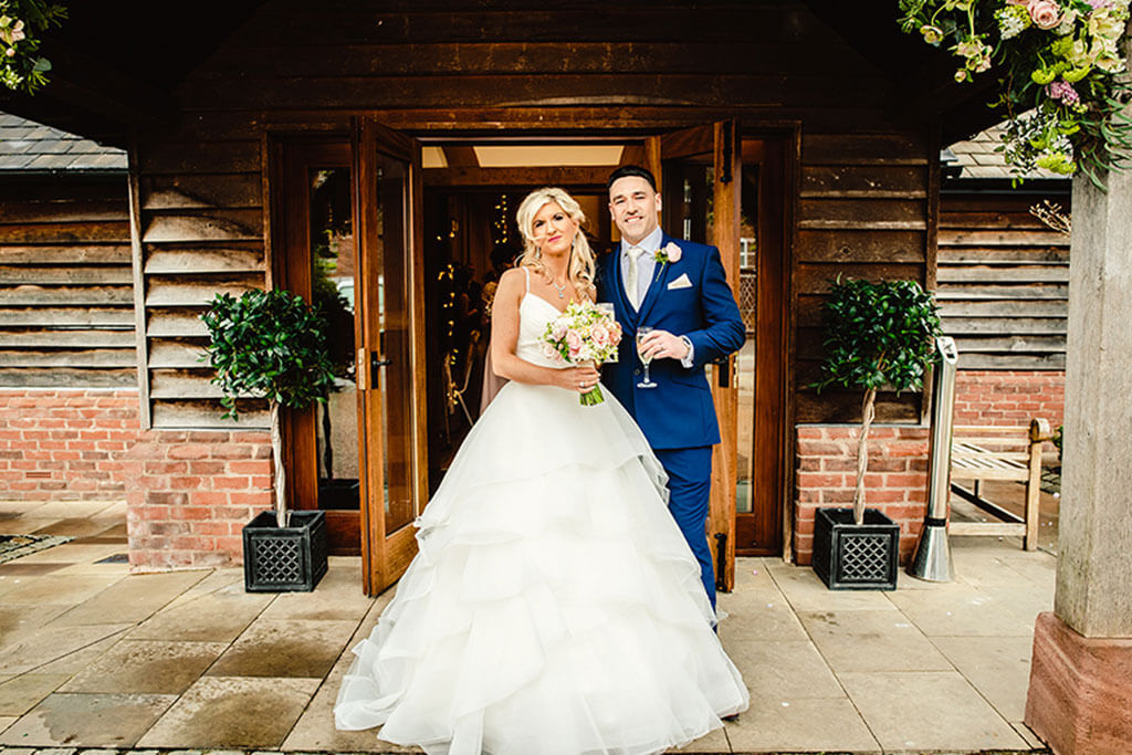 Rebecca and Graeme outside the barn at Sandhole Oak Barn