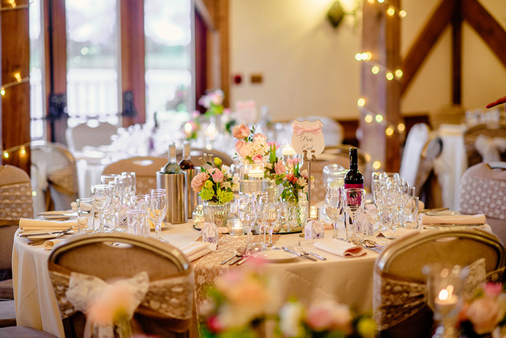 Floral table decorations at Rebecca and Graeme's wedding at Sandhole Oak Barn