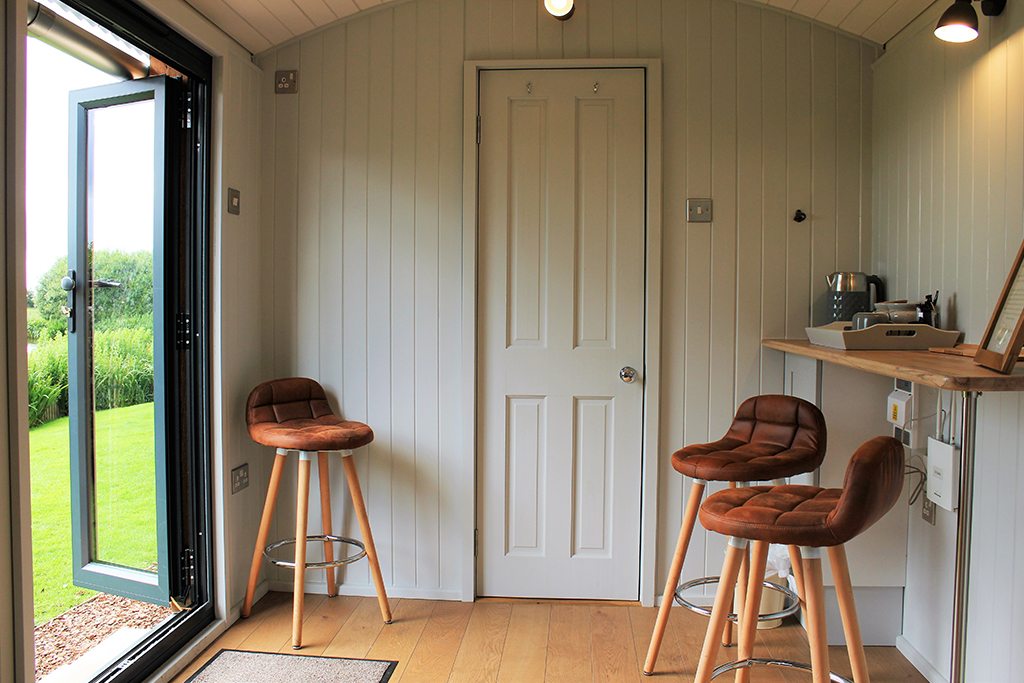 The breakfast bar and stools in the Shepherds hut at Sandhole Oak Barn wedding venue in Cheshire