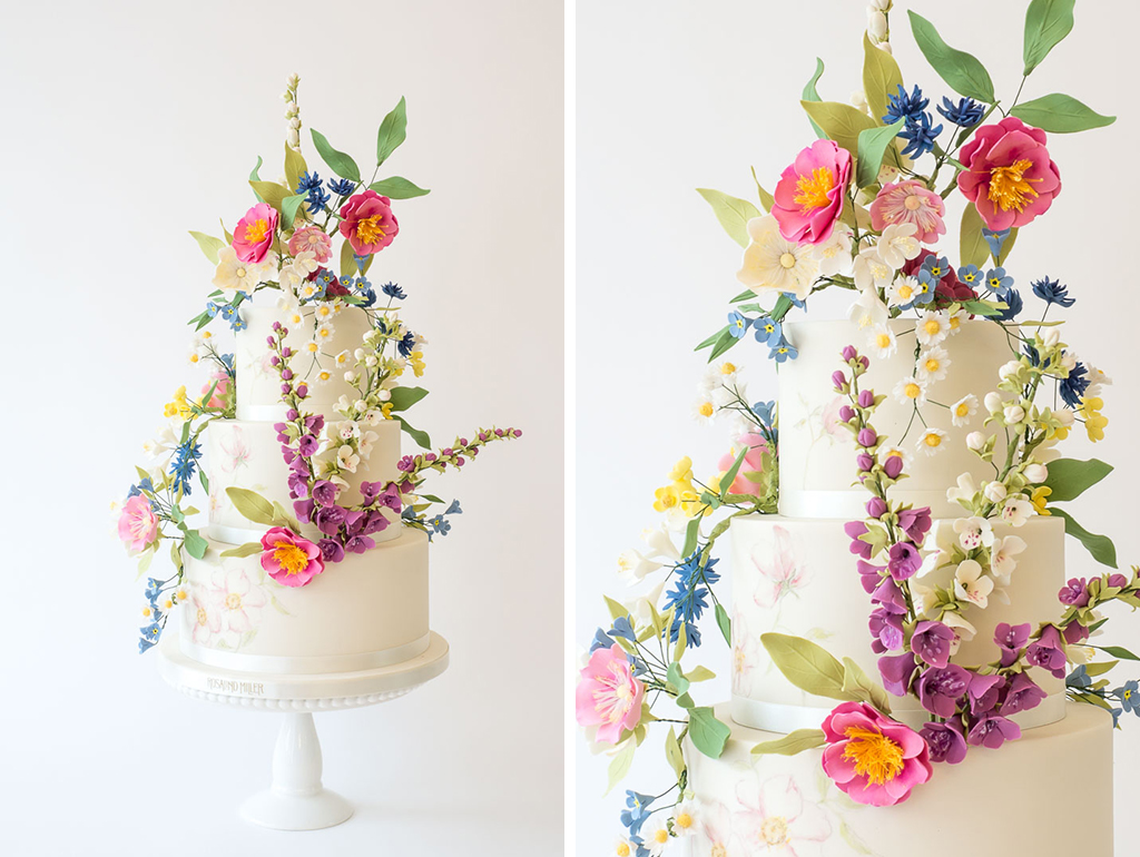 This three-tier white iced wedding cake has been decorated with lots of beautiful sugar flowers and is perfect for your barn wedding