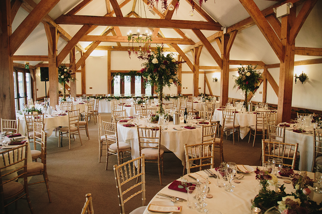 The oak barn is beautifully decorated with festive wedding flowers and decorations at Sandhole Oak Barn