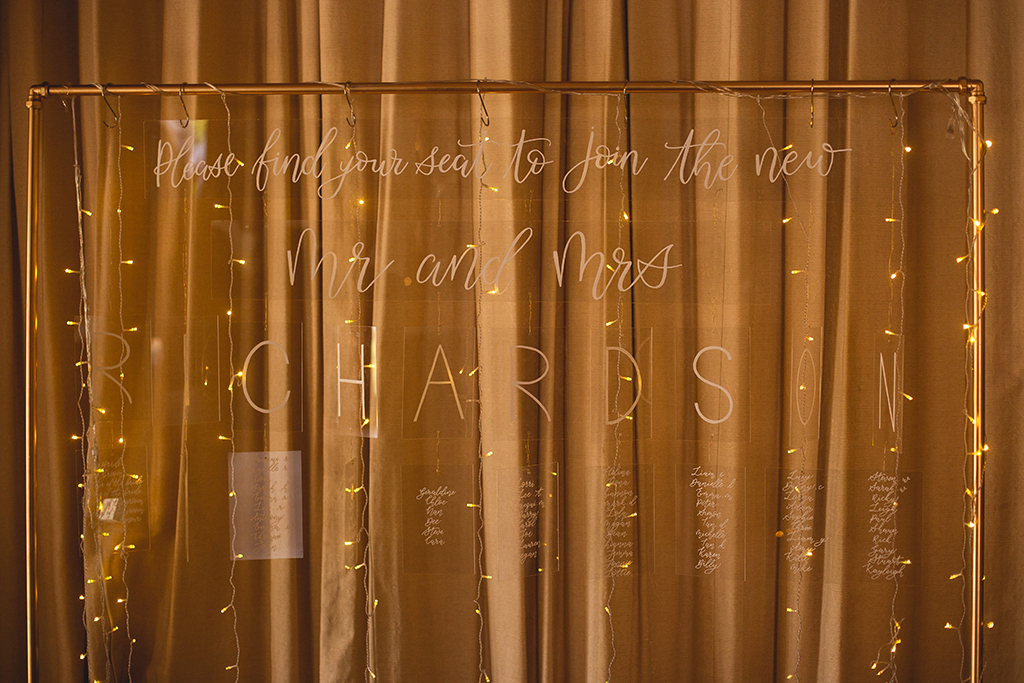 The unusual table plan was made from printed Perspex hanging from a rose gold frame at this spring barn wedding near Manchester