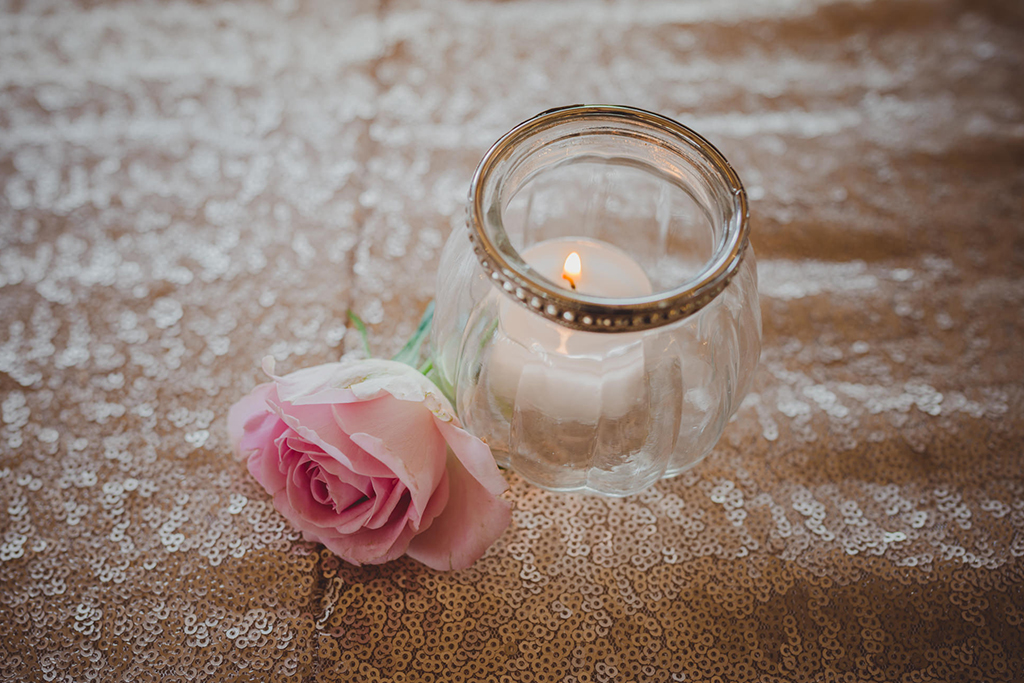 Tealights in pretty glass jars were used to decorate this barn wedding at Sandhole Oak Barn