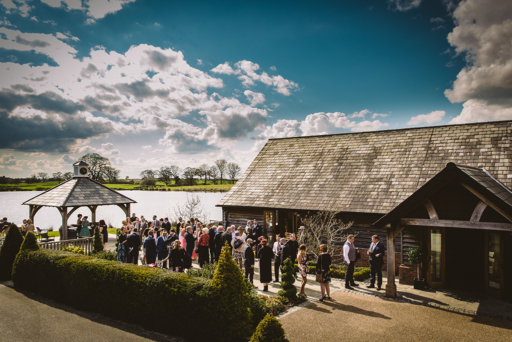 The verandah at Sandhole Oak Barn with its lake views is the perfect spot for you and your guests to mingle in the sunshine