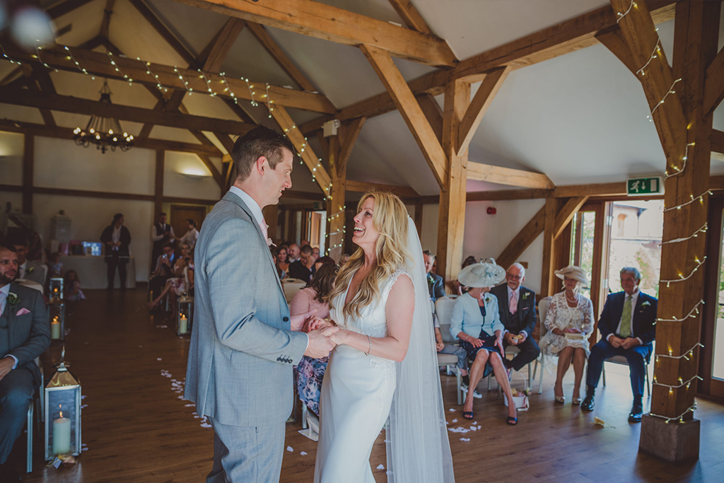 The happy couple say their vows at their wedding ceremony at Sandhole Oak Barn 