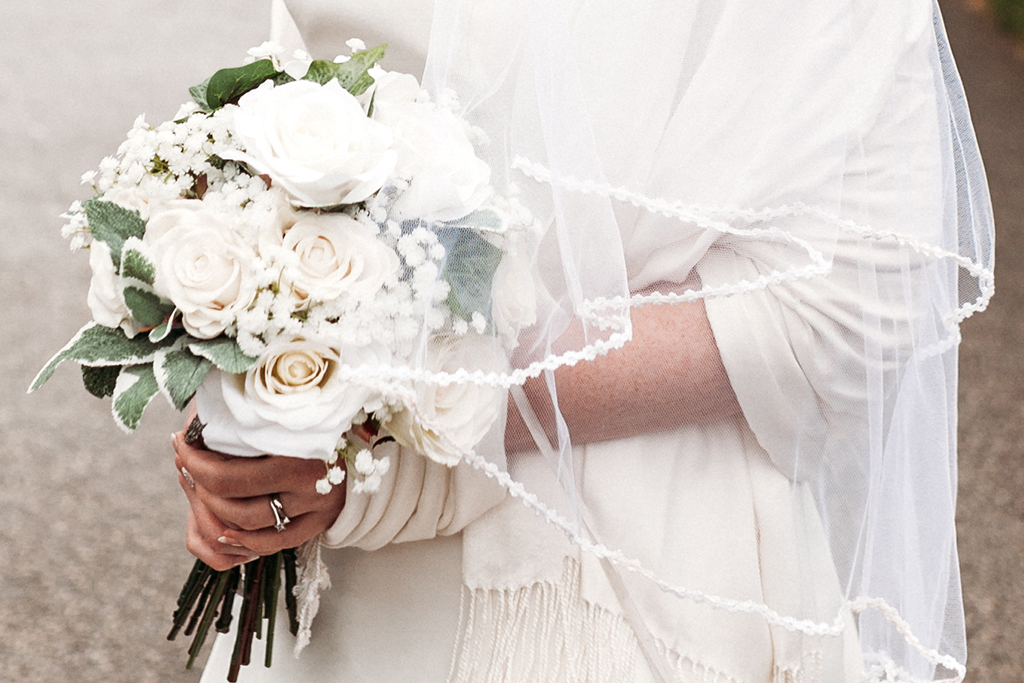 The brides bouquet was created using white roses, gypsophila and lush greenery at this barn wedding in Cheshire 
