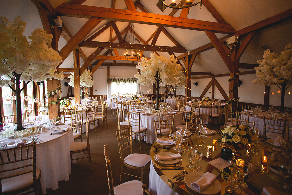 The Oak Barn looked beautiful with white blossom tree table centrepieces and tealights at this Spring wedding at Sandhole Oak Barn in Cheshire