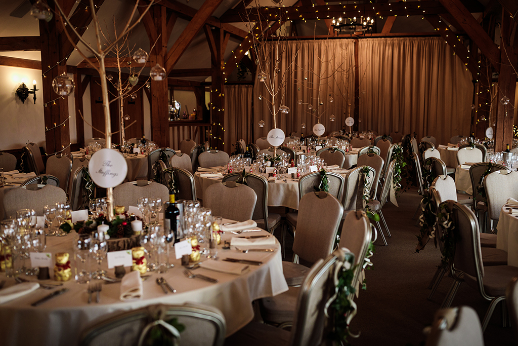 The barn at Sandhole Oak Barn was decorated with twinkly fairy lights and festive items at this winter wedding in Cheshire
