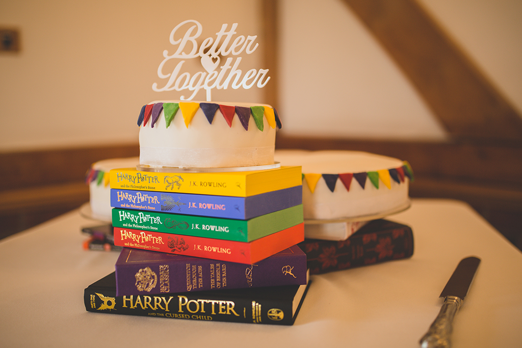 The wedding cake was made from three white iced tiers decorated with colourful fondant bunting and displayed on the couples’ favourite books
